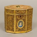 An early 19th century rolled paper tea caddy Of octagonal hinged form,