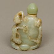 A Chinese carved green and russet jade s