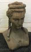 A 19th century terracotta bust Modelled as young woman with her hair in ringlets. 46 cm high.