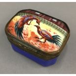 An enamel patch box decorated with a cock fighting scene
