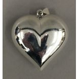 A large silver heart pendant