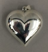 A large silver heart pendant