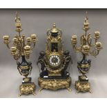 A gilt metal and bronze triple clock garniture