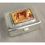 A silver pill box depicting a horse