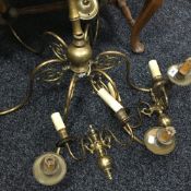 A brass hanging chandelier and a pair of wall lights