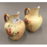 A pair of Royal Worcester ewers