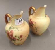 A pair of Royal Worcester ewers