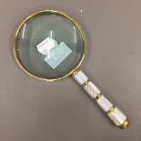 A mother-of-pearl magnifying glass