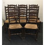 A set of eight rush seated ladder back dining chairs