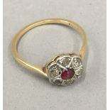 A diamond and ruby flower head ring (1.