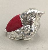 A silver pin cushion in the form of a bird