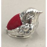 A silver pin cushion in the form of a bird