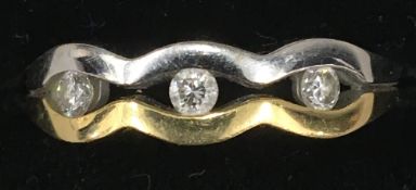 An 18 ct gold three stone diamond ring,