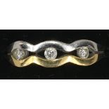 An 18 ct gold three stone diamond ring,