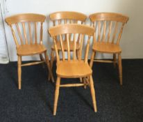 A set of four modern pine splat back kitchen chairs