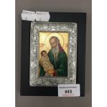 A Greek icon of a bearded saint within a silver frame