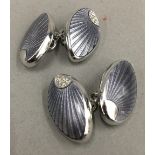 A pair of silver and enamel cufflinks