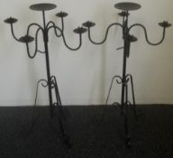 A pair of decorative wrought floor standing candelabra