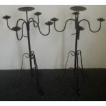 A pair of decorative wrought floor standing candelabra