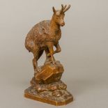 A late 19th/early 20th century Black Forest carved wooden model of a mountain goat,