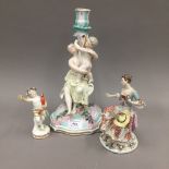 Two 19th century Continental porcelain figurines and a figural candlestick
