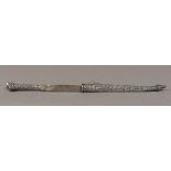An Ottoman white metal (tests as silver) Kird, the handle and sheath with foliate decoration,