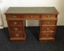 An Edwardian walnut pedestal desk