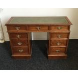 An Edwardian walnut pedestal desk