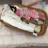 A basket of child's dolls, linen, etc.