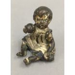 A small cold painted bronze model of a baby