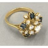 An 18 ct gold diamond and sapphire set ring,