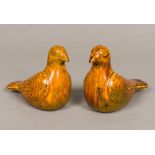 A pair of Chinese porcelain bird figures, naturalistically modelled with allover amber glaze.