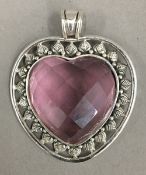 A silver and pink stone heart pendant