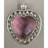 A silver and pink stone heart pendant