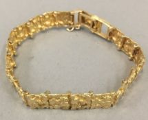 An 18 K gold nugget bracelet (29.