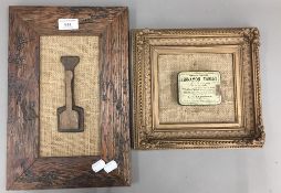 A framed butter spatulas and a framed lozenge tin