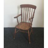 A Victorian stick back solid seated open armchair