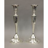 A pair of sterling silver candlesticks