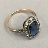 A 9 ct gold and silver ring set with a large blue stone)