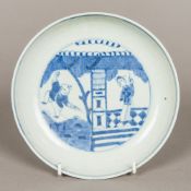 A Chinese blue and white porcelain dished plate, centrally worked with figures in a pagoda,