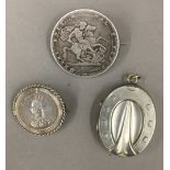 Two Victorian coin brooches together with a white metal horseshoe pendant locket