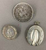 Two Victorian coin brooches together with a white metal horseshoe pendant locket