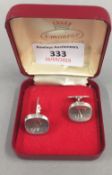 A pair of silver cufflinks,