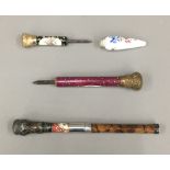 Three Victorian parasol handles and a scent bottle