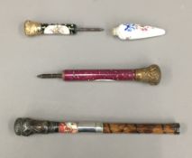 Three Victorian parasol handles and a scent bottle