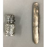 A small silver perfume bottle,