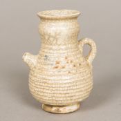 A Chinese porcelain water dropper, of baluster ribbed form, with allover crackled creamy glaze.