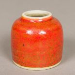 A Chinese porcelain brush wash Of beehive form, with allover mottled iron red glaze. 5.5 cm high.