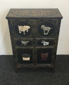 A Chinese stone set lacquered side cupboard