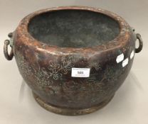 A Japanese florally decorated twin handled copper censer